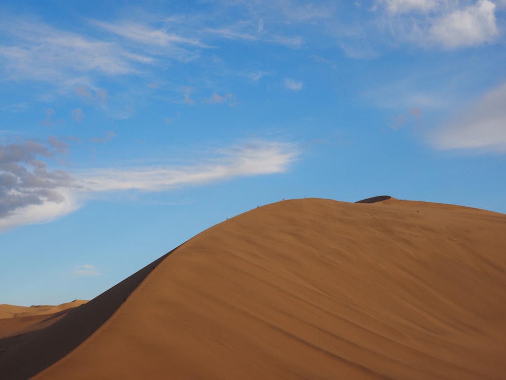 brown sand under blue sky during daytime