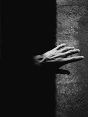 grayscale photo of persons hand