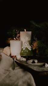 A cozy setting with candles and holiday decorations.