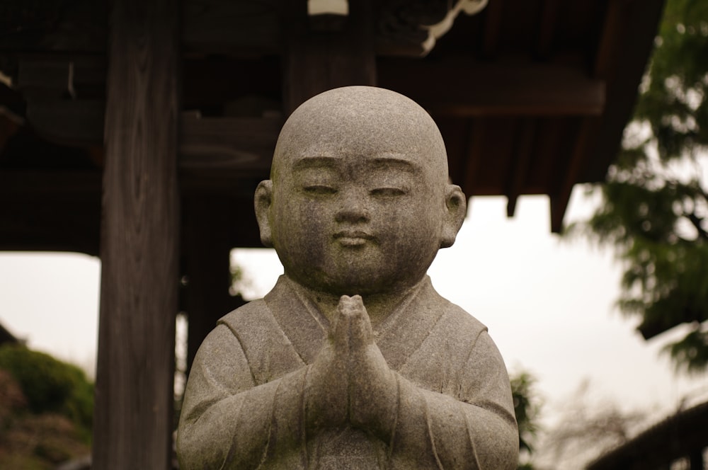 grayscale photo of man statue