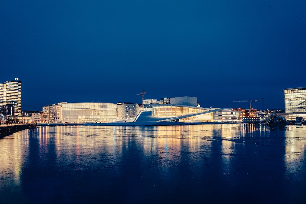 white concrete building near body of water during night time