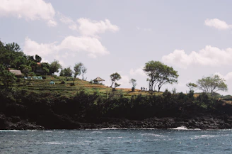 A serene coastal scene in the Var Valley with a group engaged in a lively outdoor tech workshop by the sea.