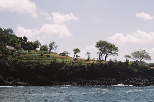 A serene coastal scene in the Var Valley with a group engaged in a lively outdoor tech workshop by the sea.