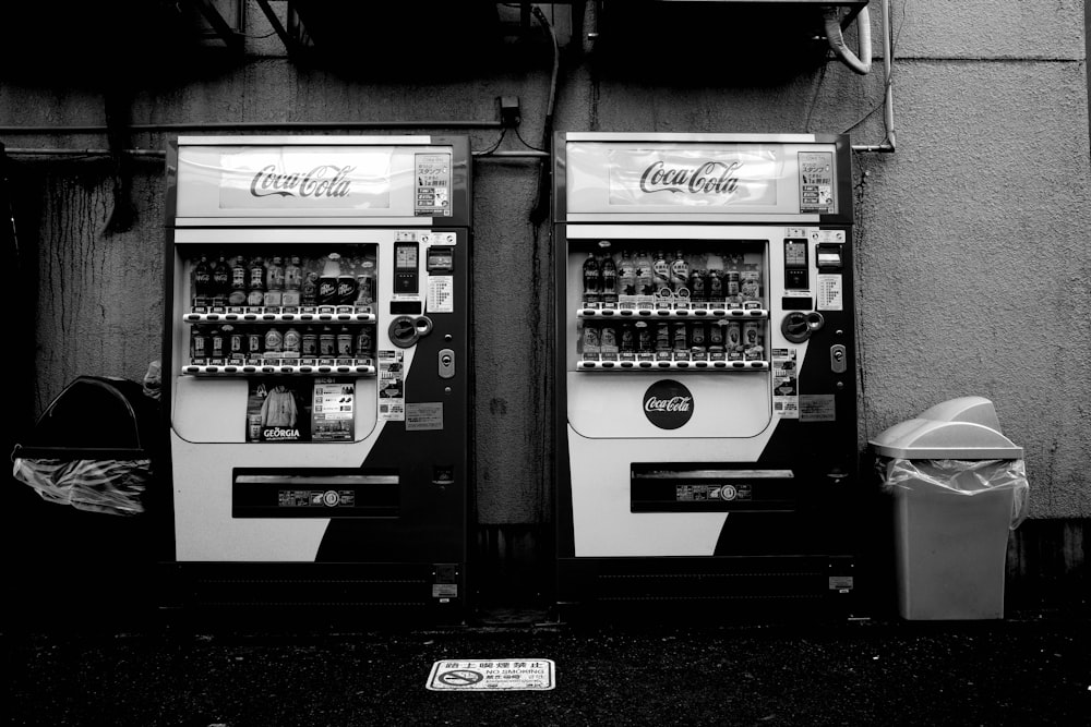 gray scale photo of vending machine