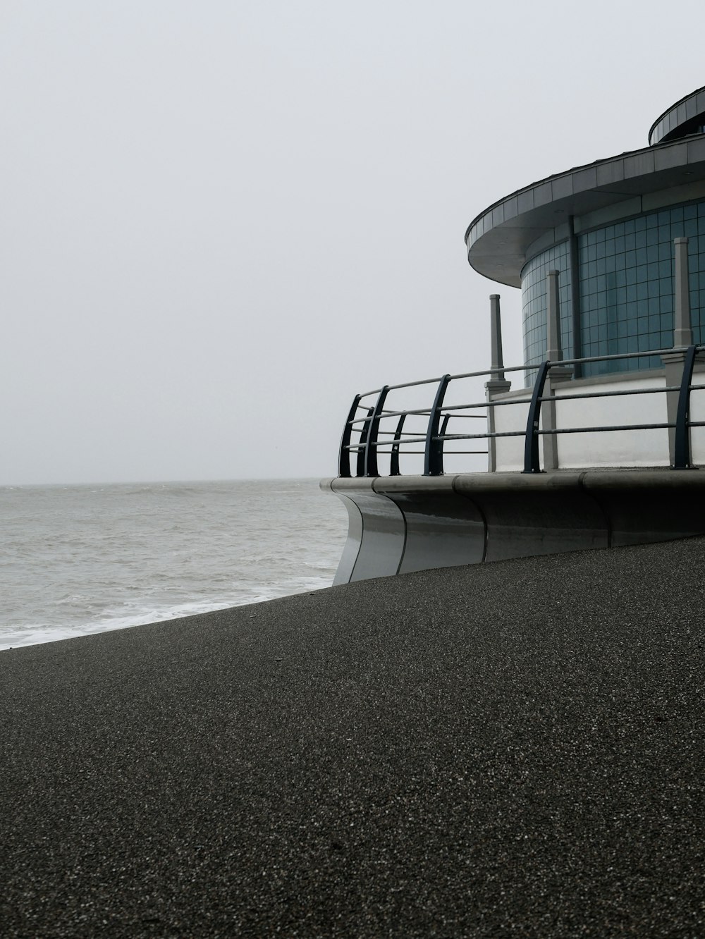 white and black concrete building on white sand beach during daytime