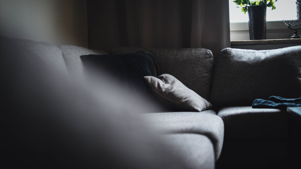 gray throw pillows on gray couch