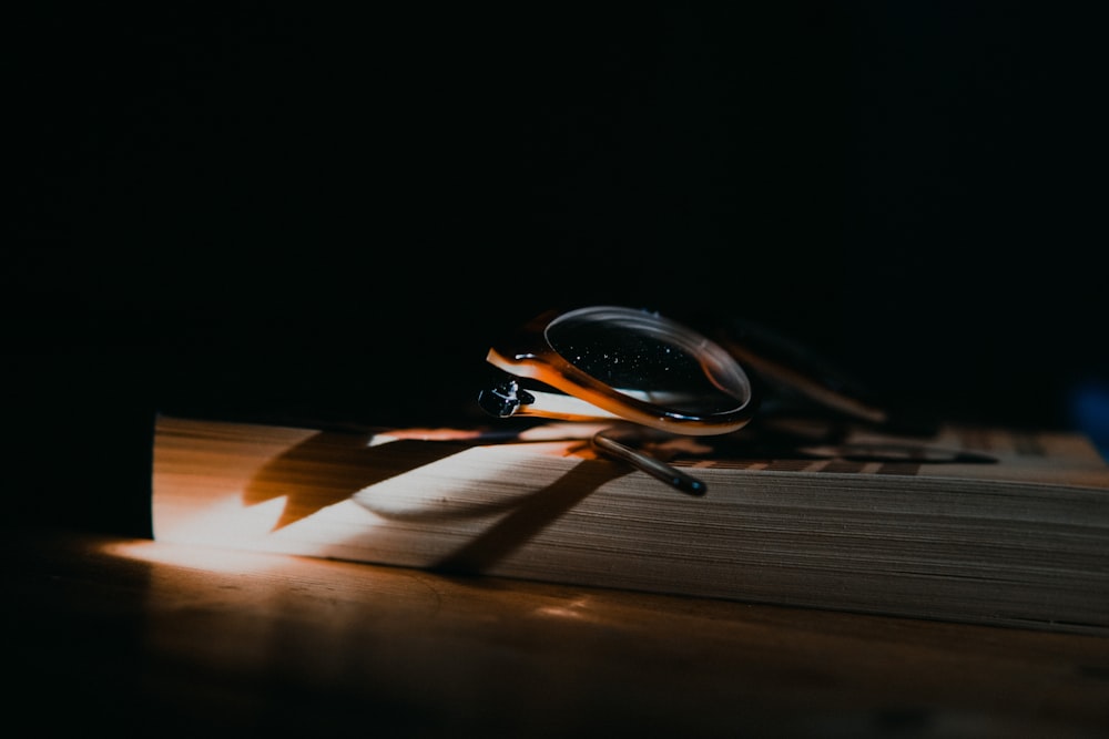 black framed sunglasses on brown wooden table