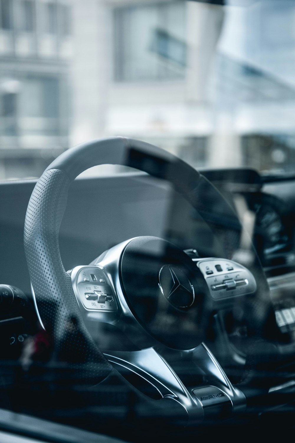 black steering wheel in grayscale photography