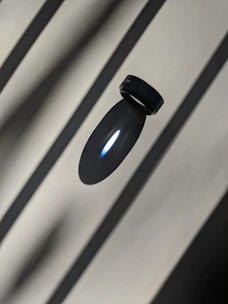 Matte black zeneio smart ring floating against a dark void with electric blue glow.