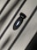 A close-up of a sleek black ring resting on a wooden surface.