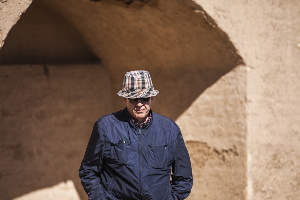 man in blue jacket wearing white hat