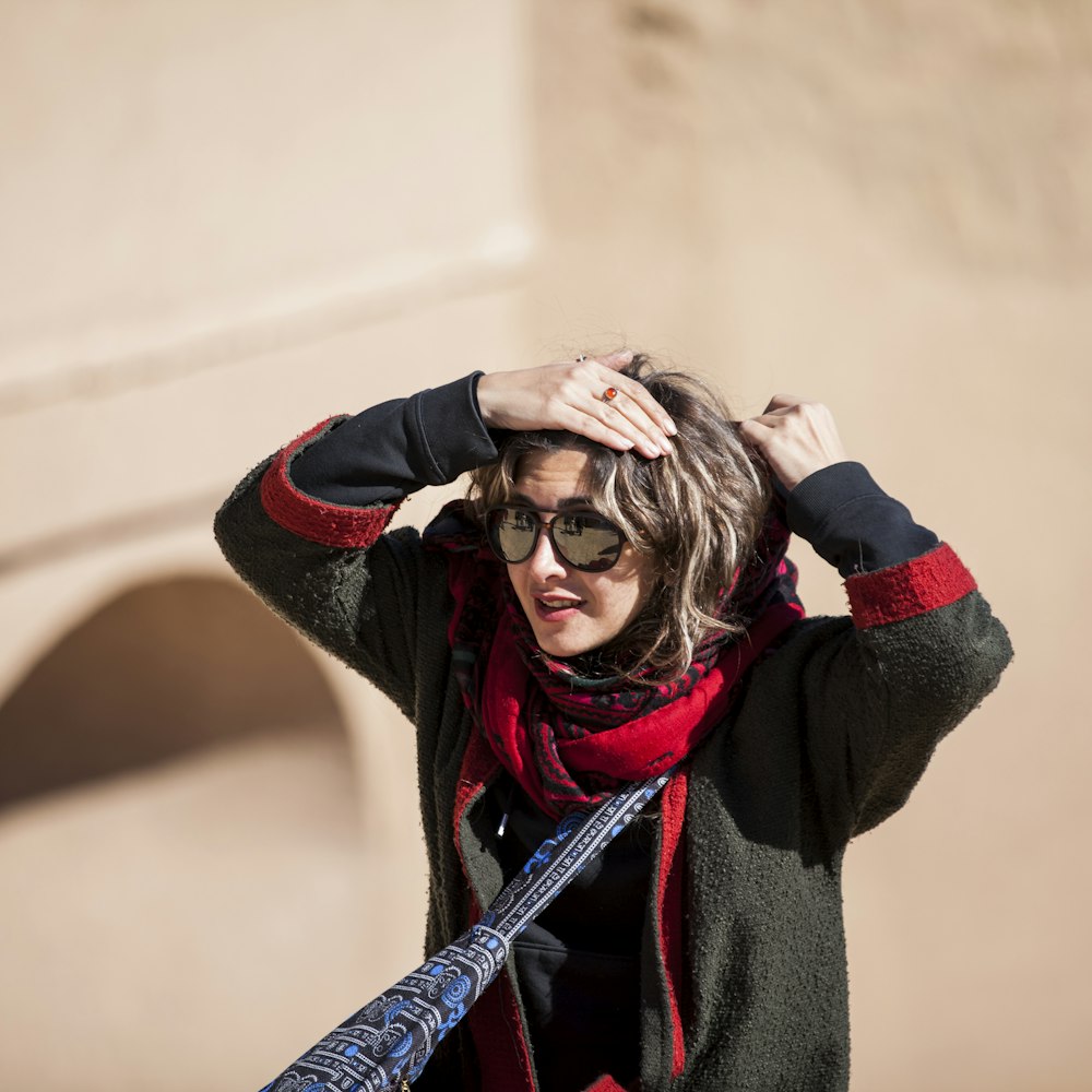 woman in black and red scarf and gray sweater