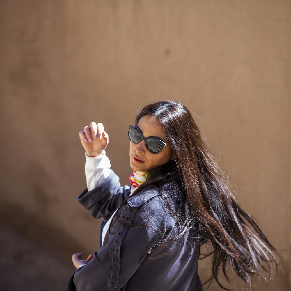 woman in black jacket wearing black sunglasses