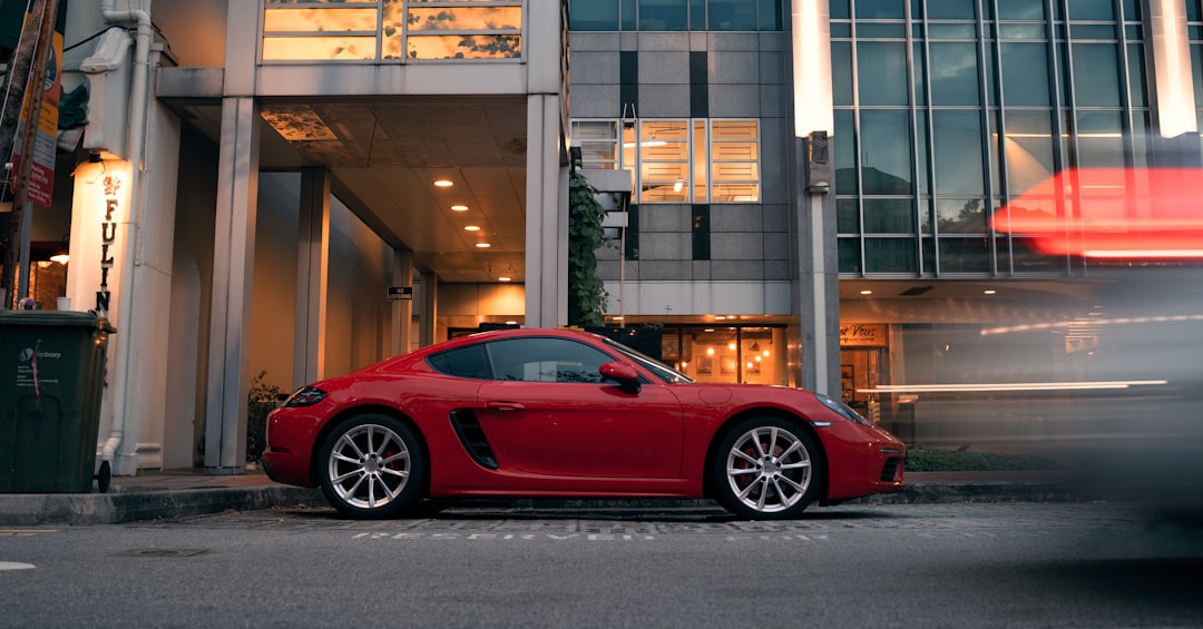 red ferrari 458 italia parked near brown building