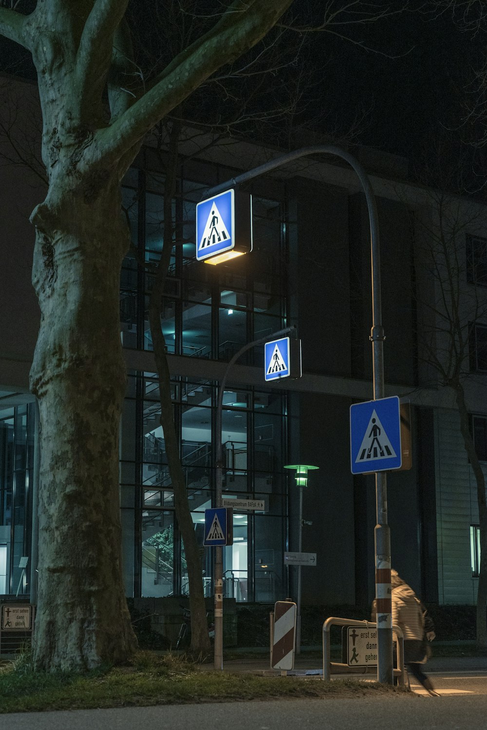 white and blue pedestrian lane sign