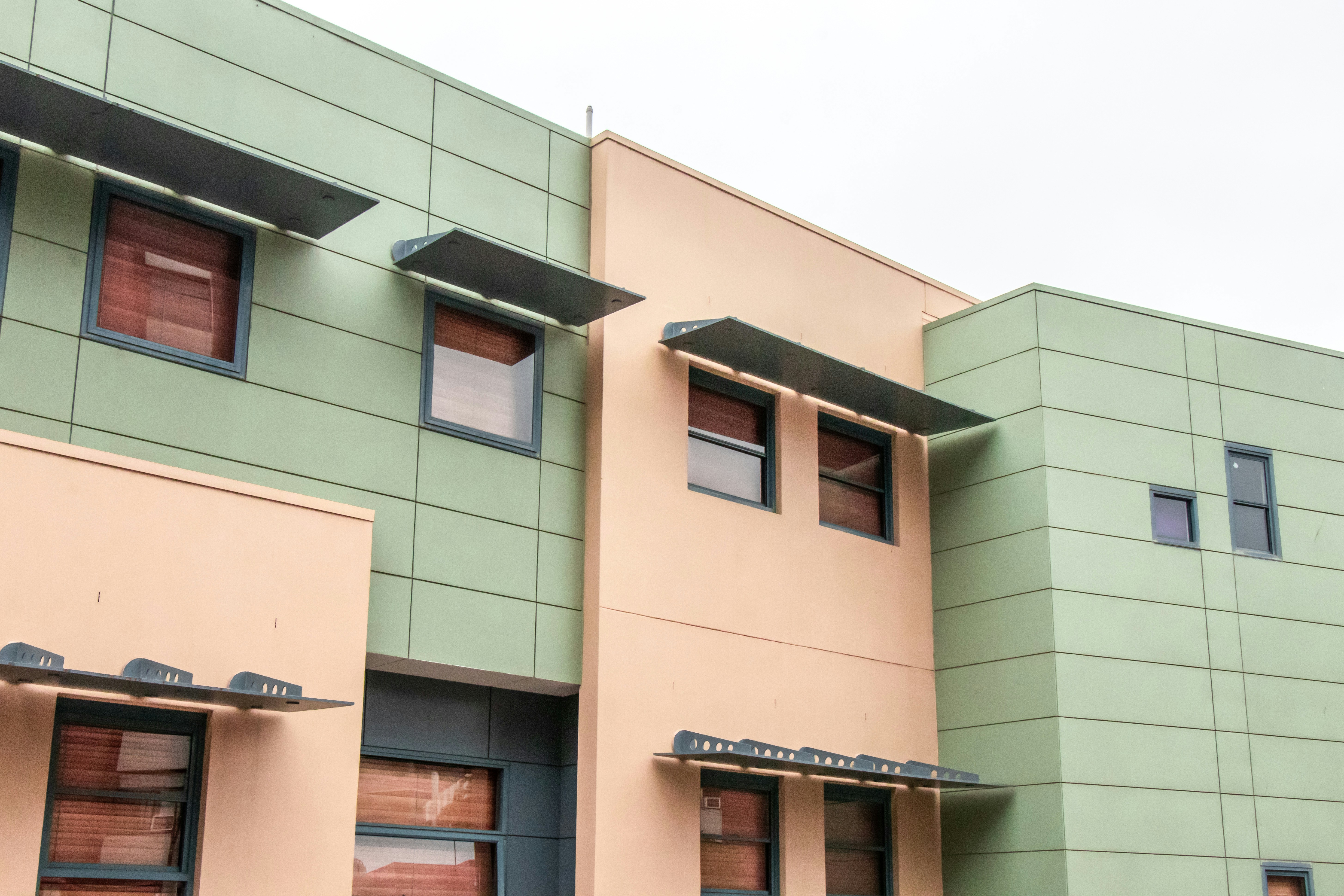Pastel green and pink apartment facade