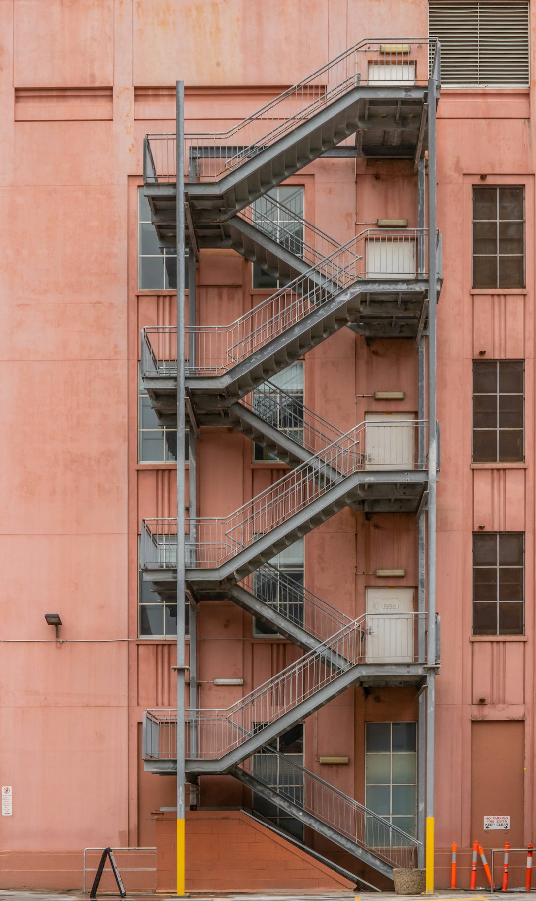 brown concrete building with black metal railings