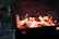 A sleek, stainless steel gas BBQ grill glowing warmly under patio lights at dusk.