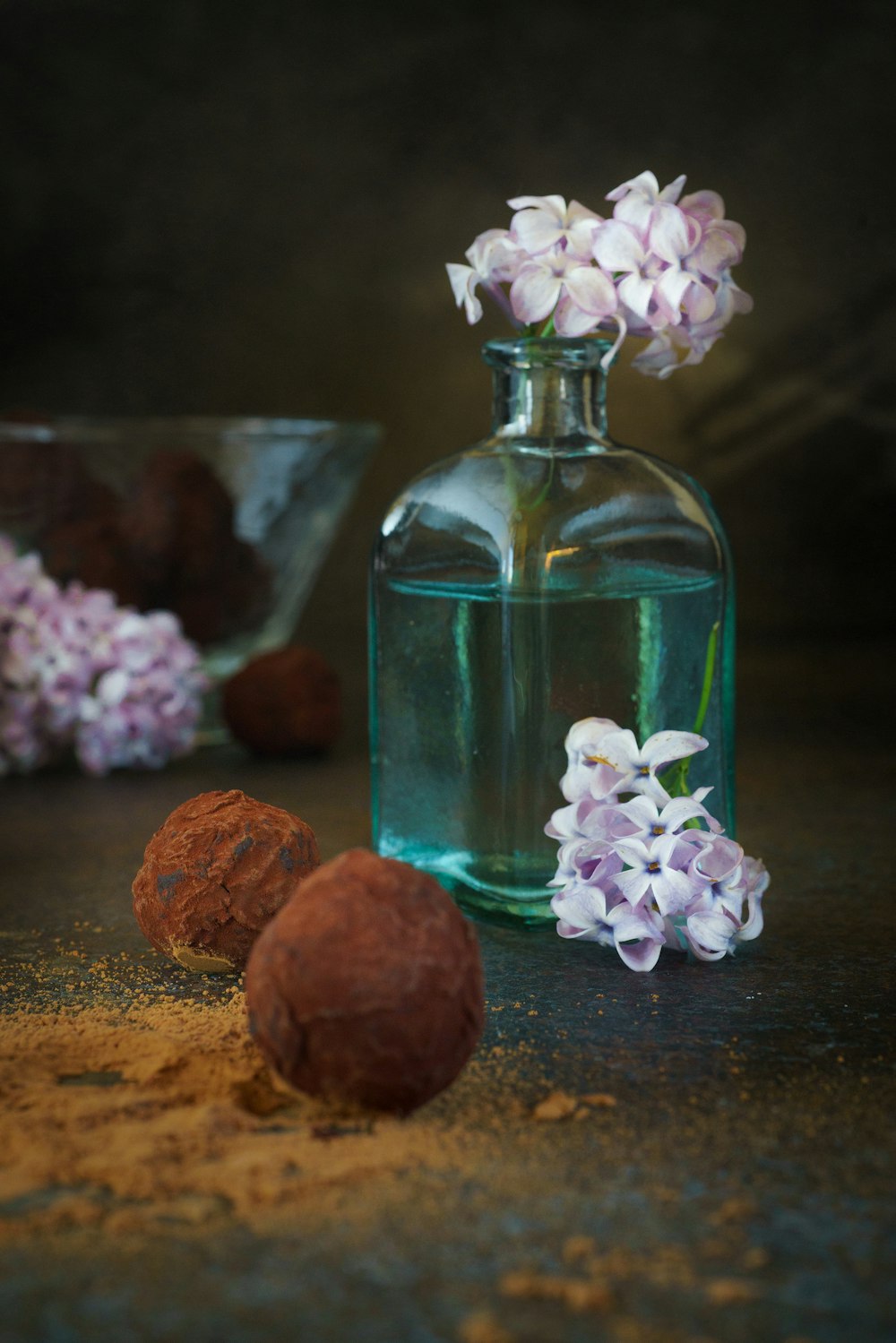 brown and white stones in blue glass bottle