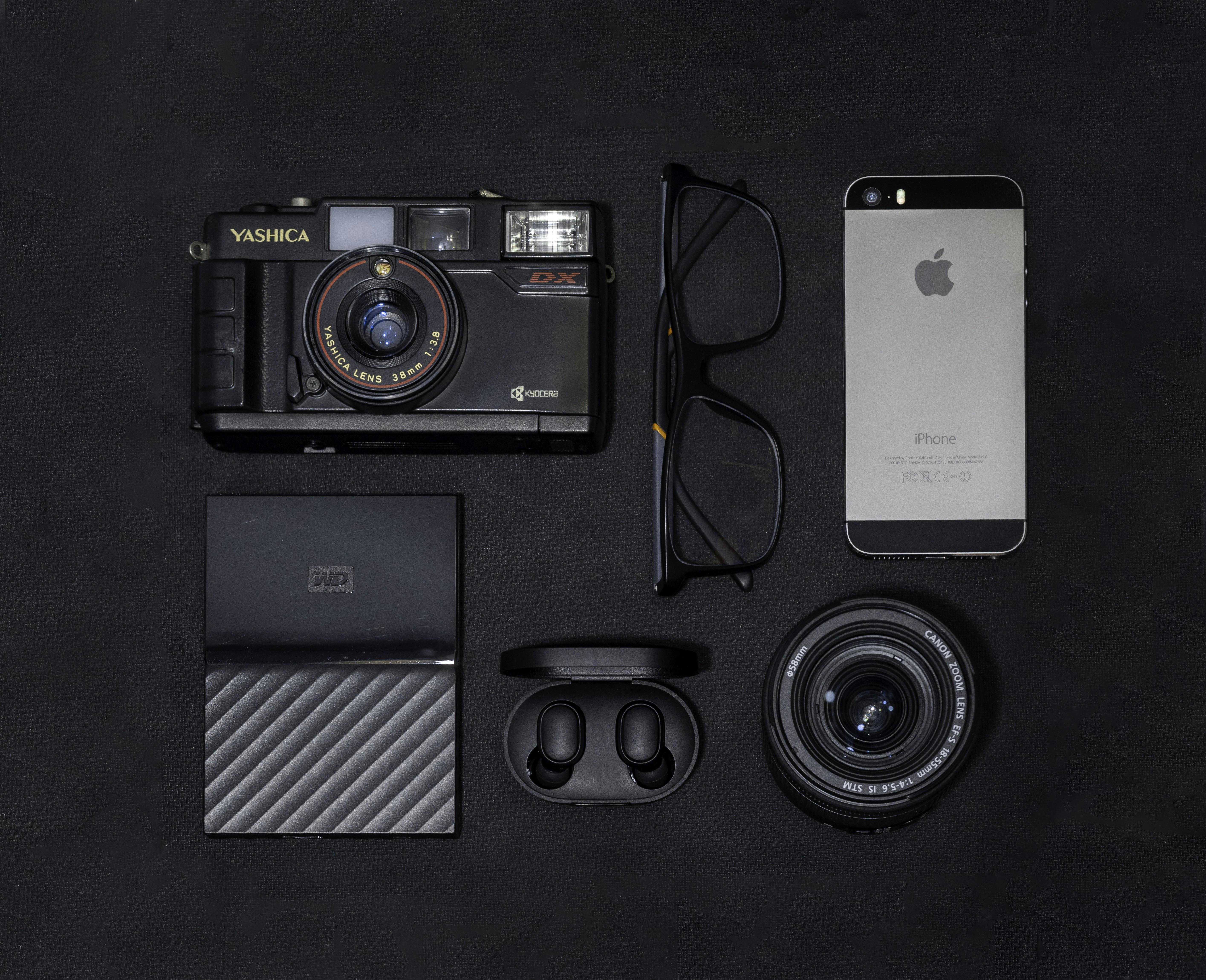 silver iphone 6 beside black and gray camera