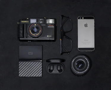 An elegant flat lay of vintage maps and modern digital devices symbolizing history and technology.