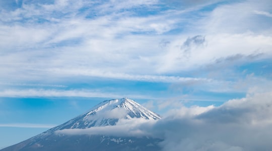 snow covered mountain under cloudy sky during daytime in Yamanashi Japan