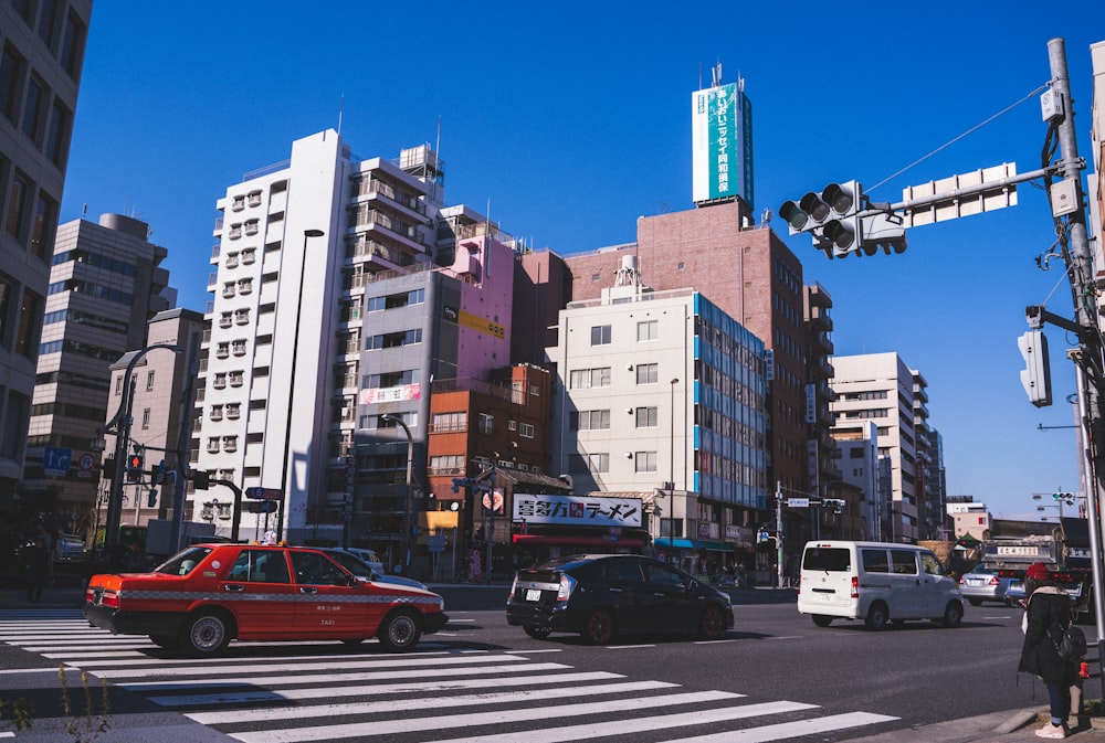 cars on road near high rise buildings during daytime