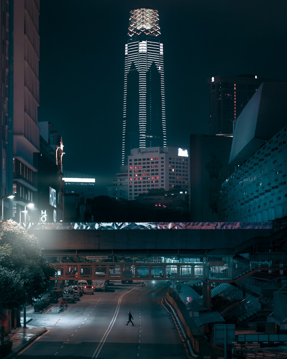 carros na estrada perto de edifícios altos durante a noite