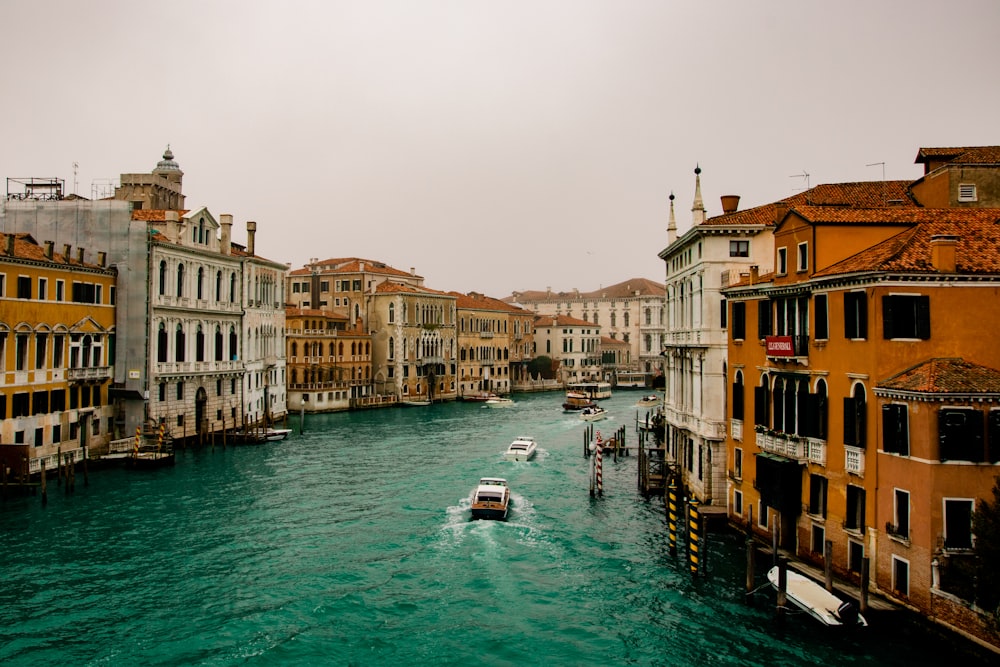 boat on water between buildings during daytime