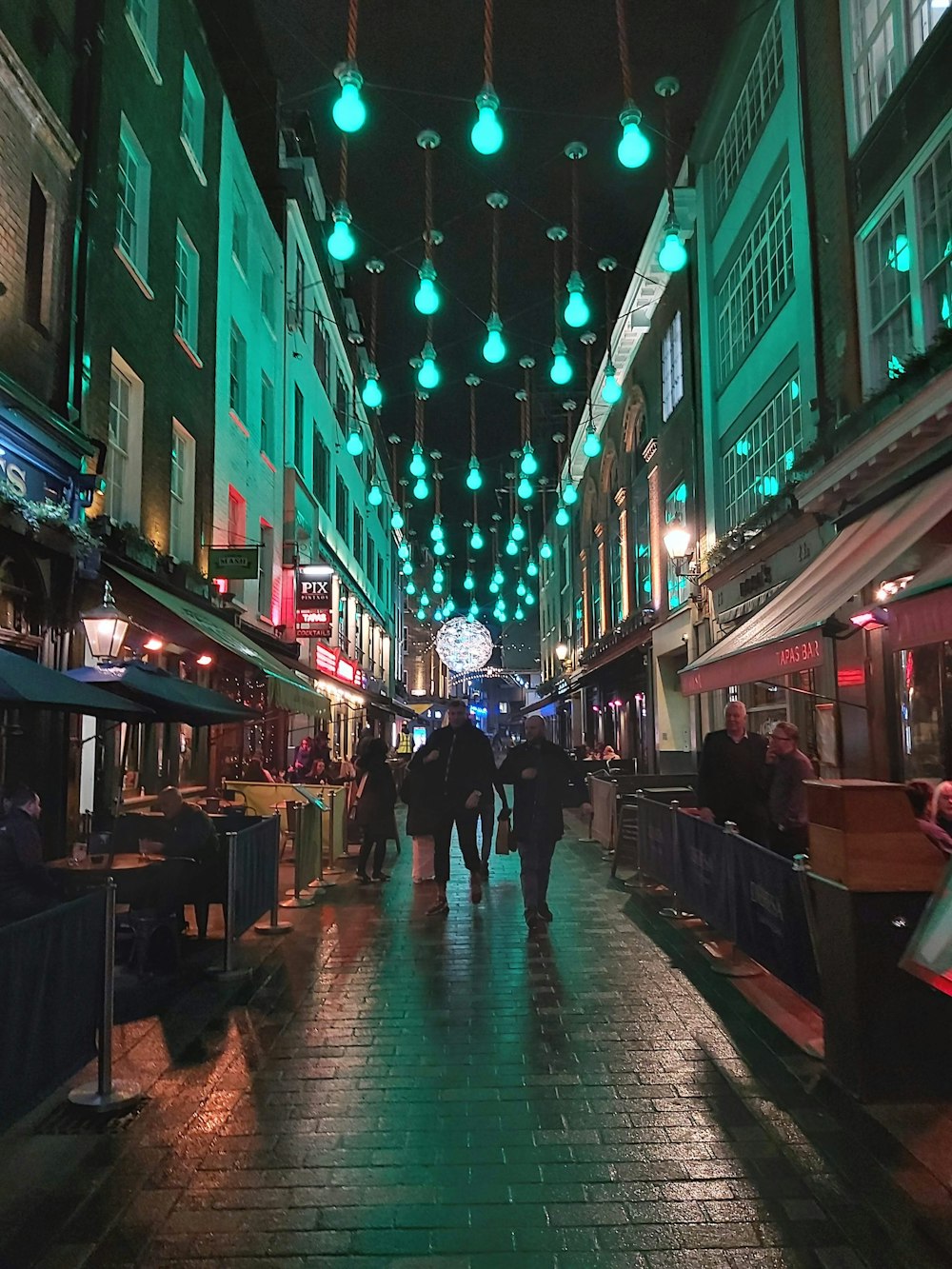 people walking on street during nighttime