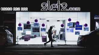 A cozy, warmly lit modern office space with a sleek car visible through the window.