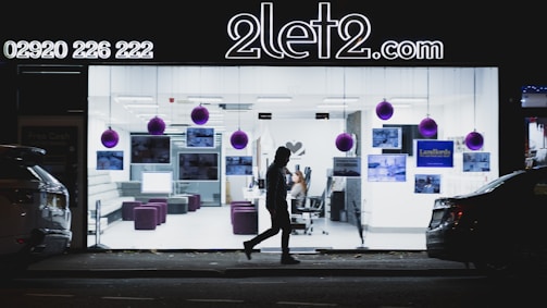 A cozy, warmly lit modern office space with a sleek car visible through the window.