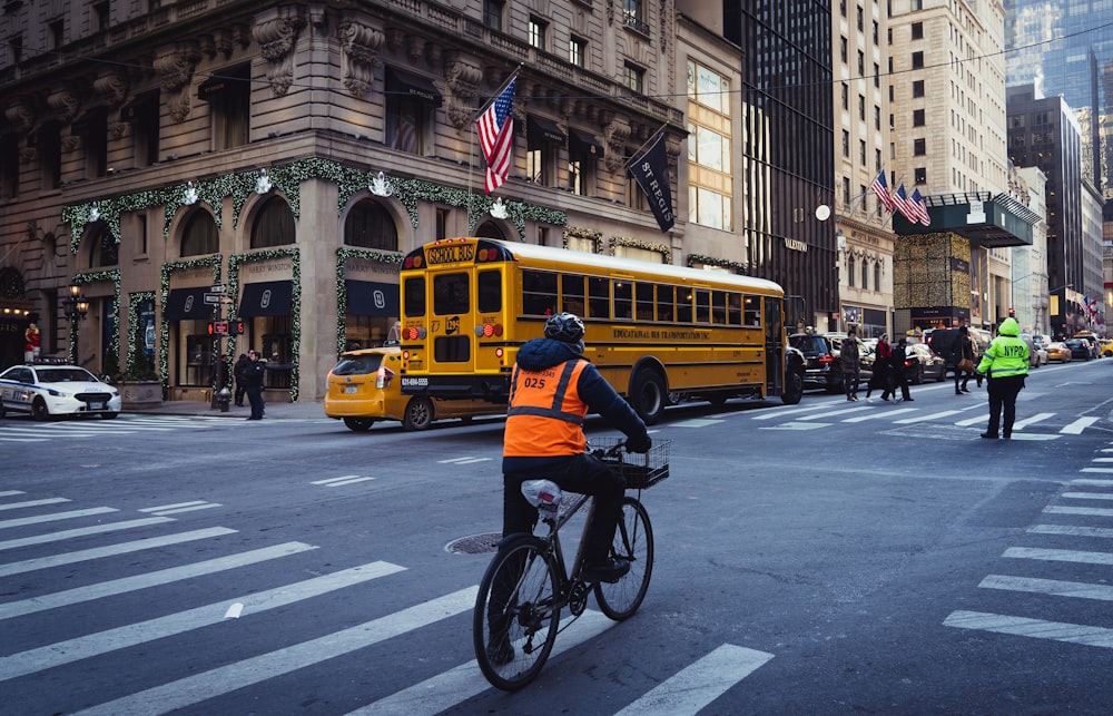 man in black jacket riding bicycle on road during daytime