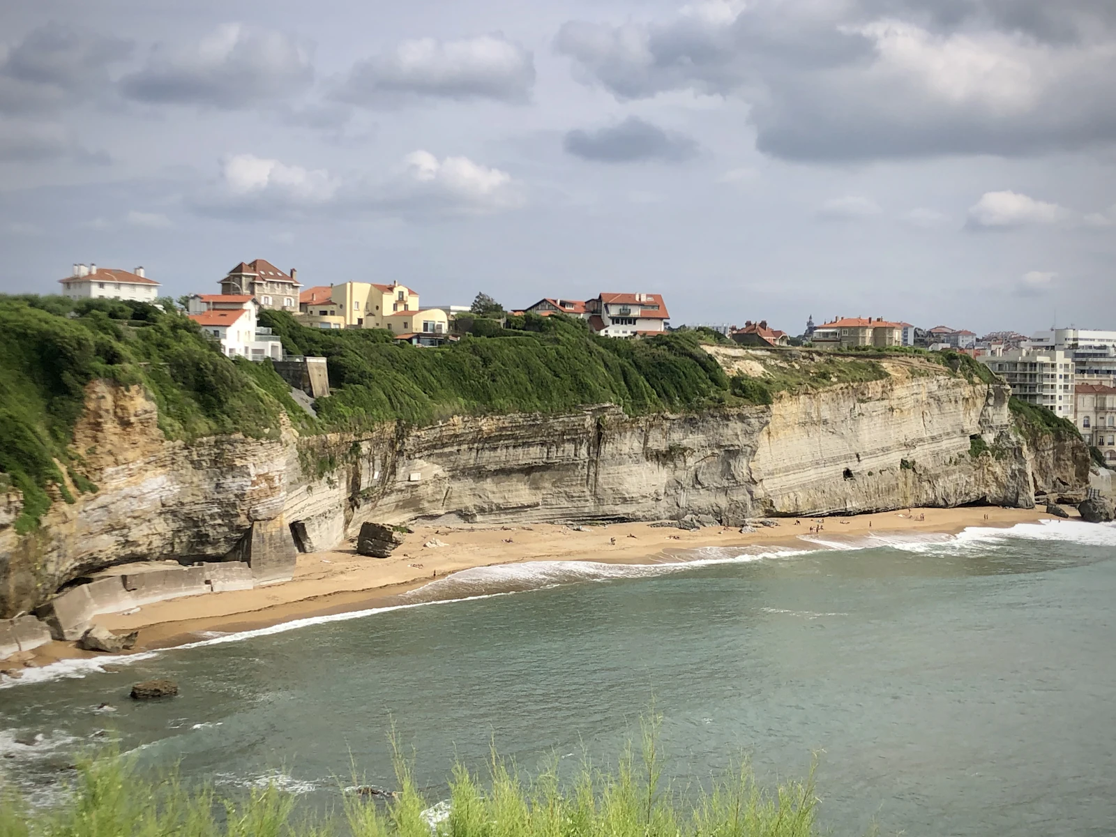 Cliffs and houses above a beach — Biarritz, France