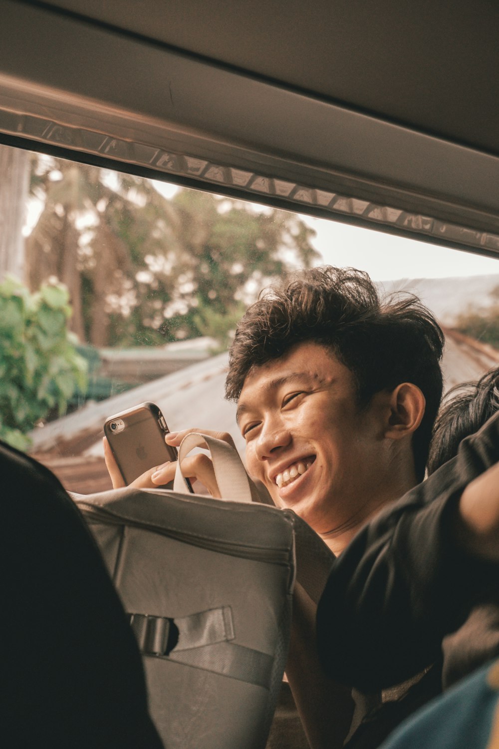 man in black jacket holding smartphone