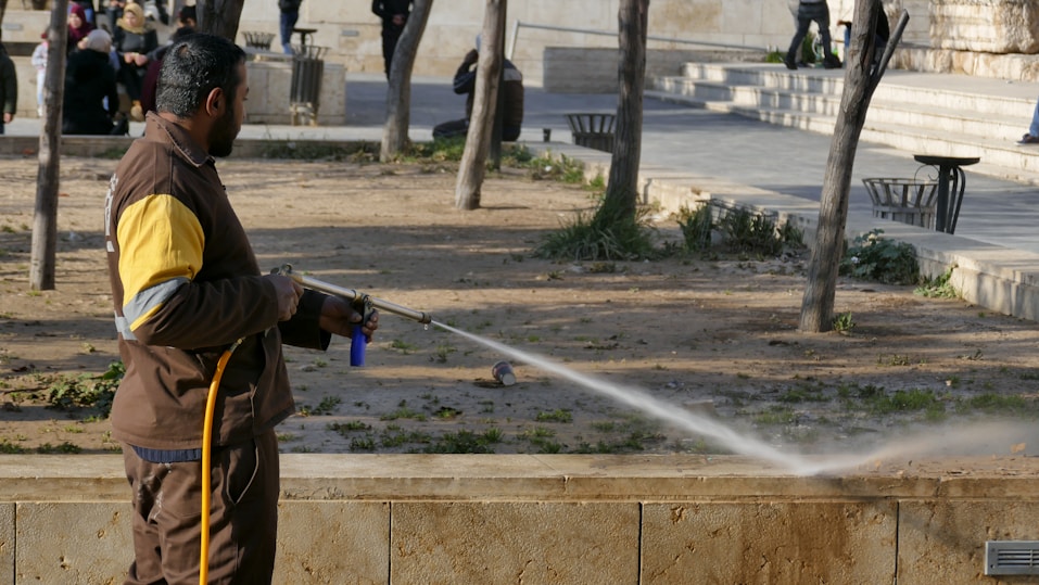 pressure washing concrete walls of a park
