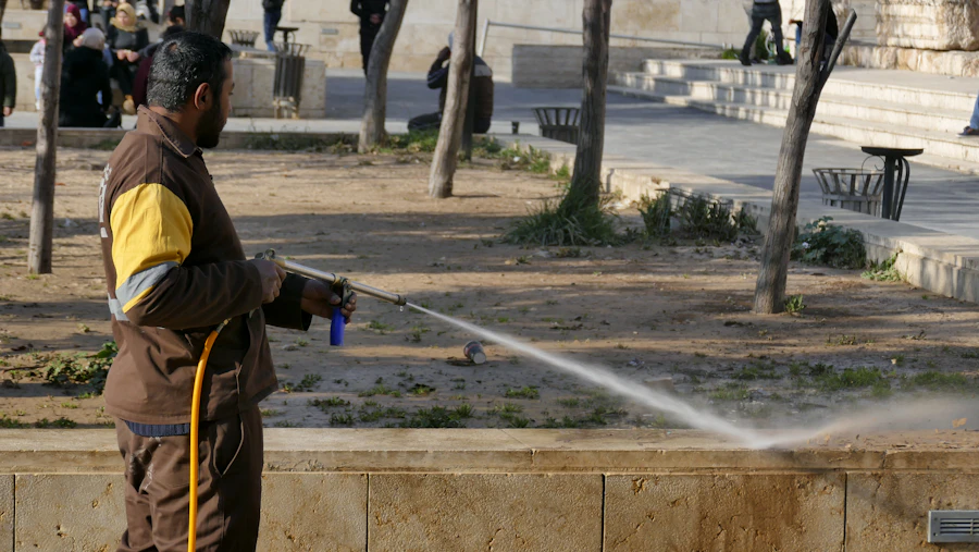 Cleaning professional with pressure washing equipment for exterior render cleaning