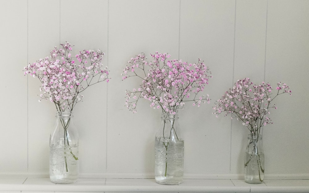 pink flowers in clear glass jar