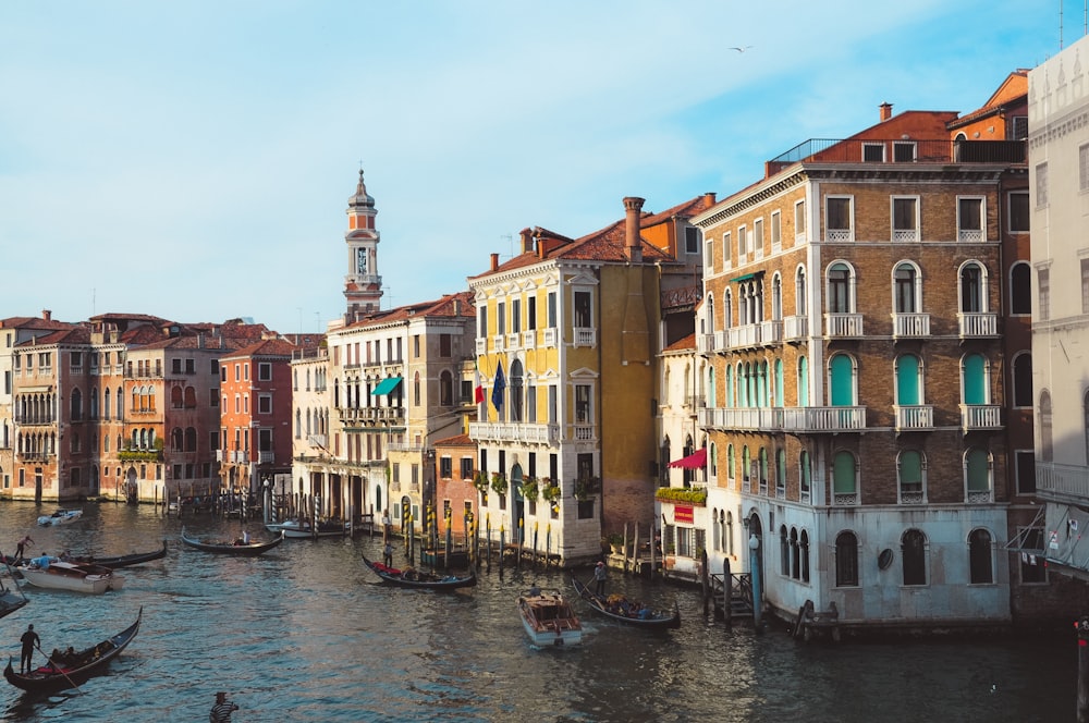 boat on river between buildings during daytime