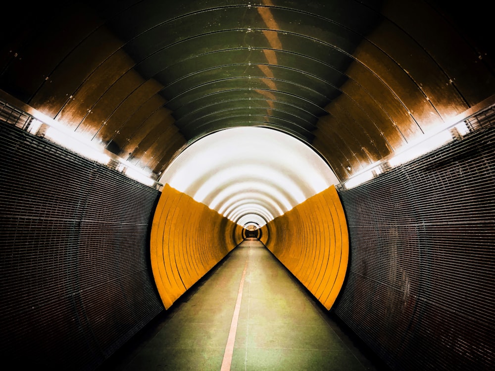 gray and yellow tunnel with white ceiling