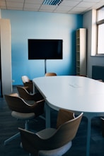 black flat screen tv mounted on white wall