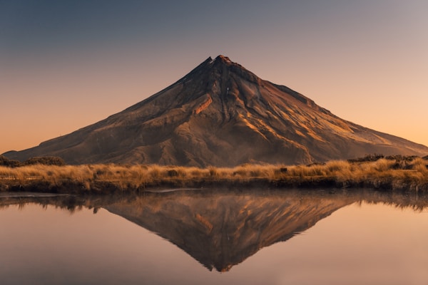 A dormant volcano reflecting in a calm lake
