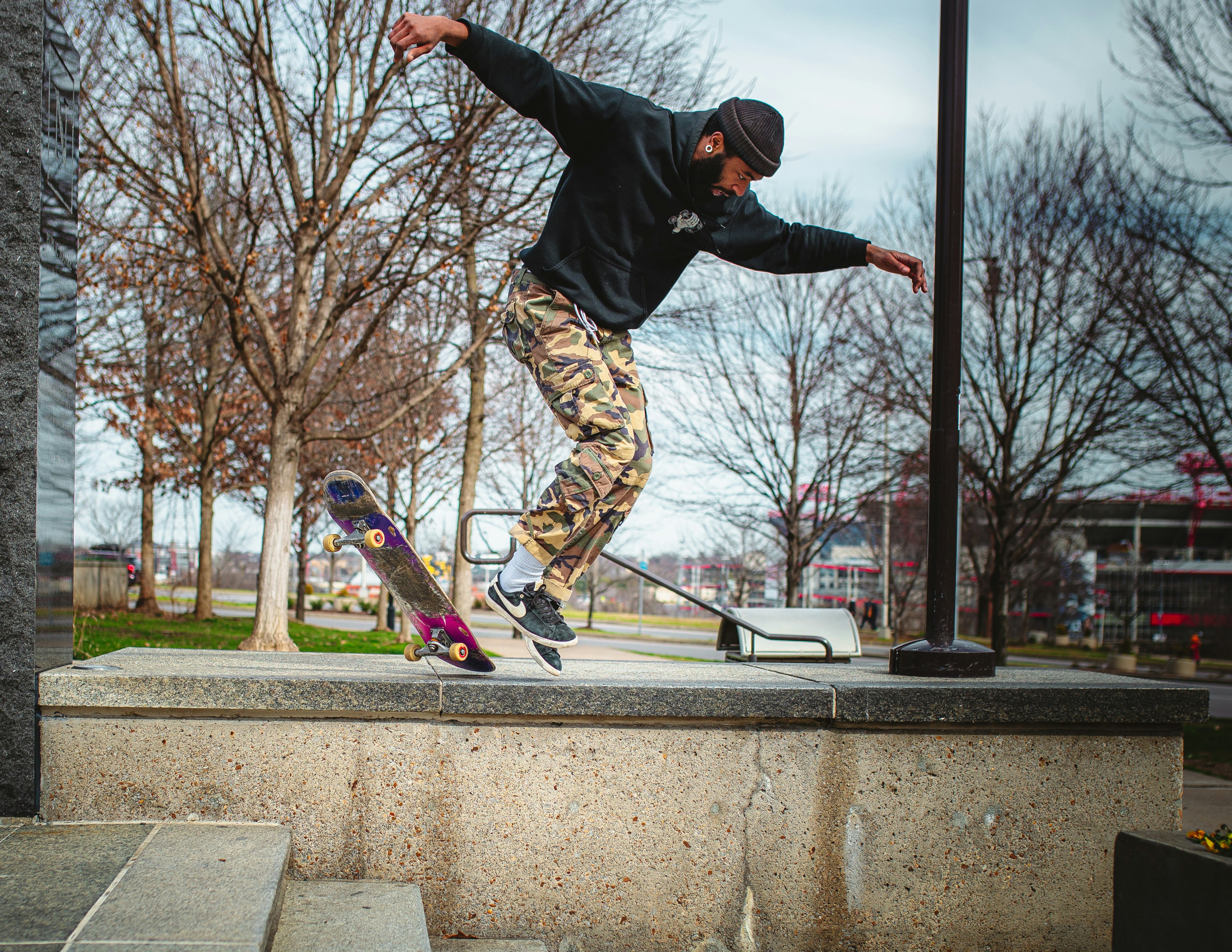 Skateboarder in black jacket and brown pants