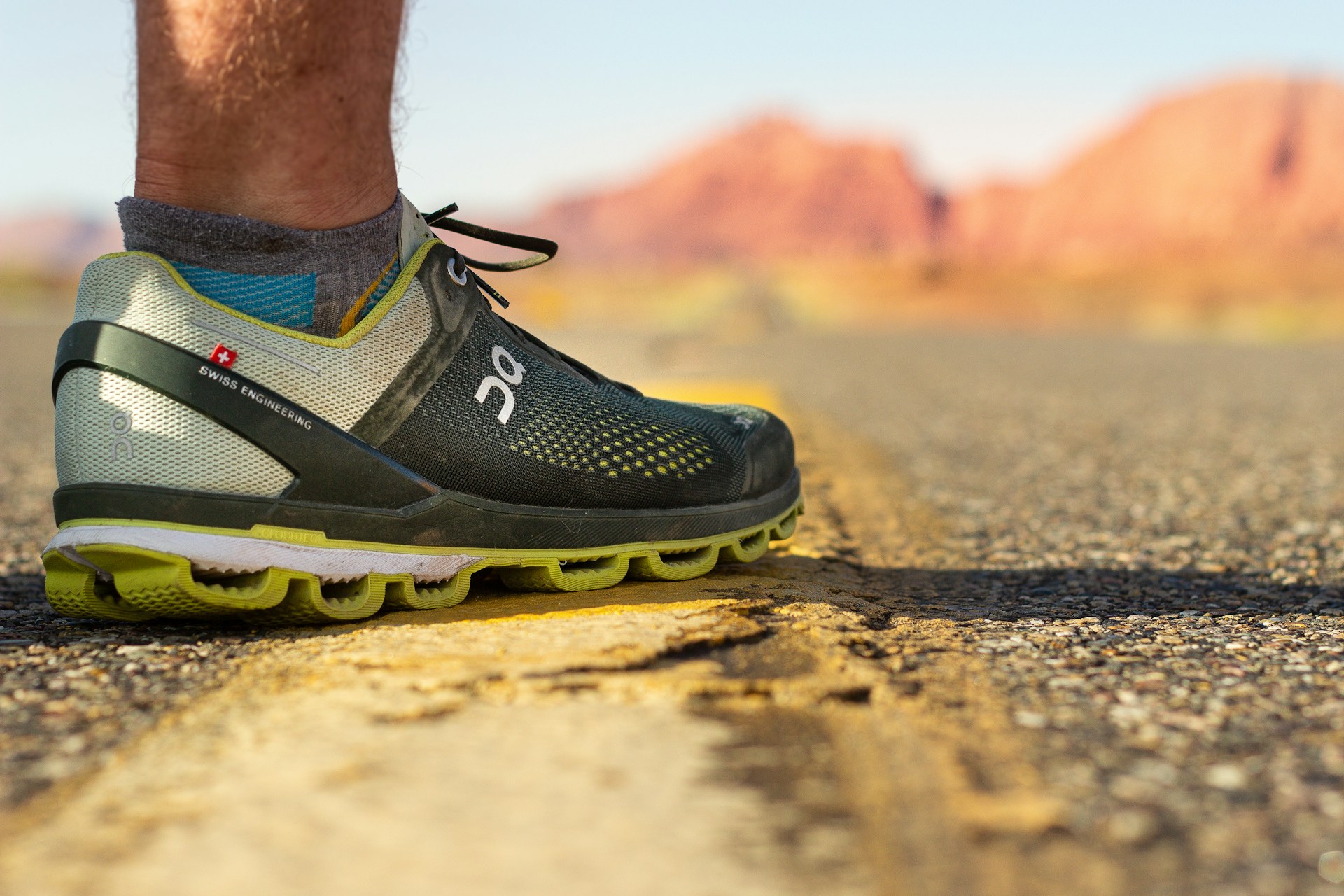 person wearing black and yellow nike running shoes