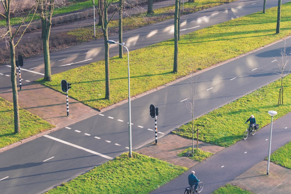 2 men walking on gray concrete road during daytime