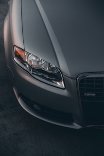 Close-up of a clean, crisp photo of a silver German car's sleek front grille and headlights.