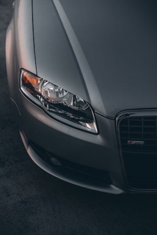 Close-up of a clean, crisp photo of a silver German car's sleek front grille and headlights.