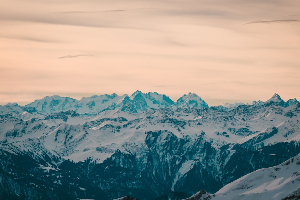 snow covered mountain under cloudy sky during daytime