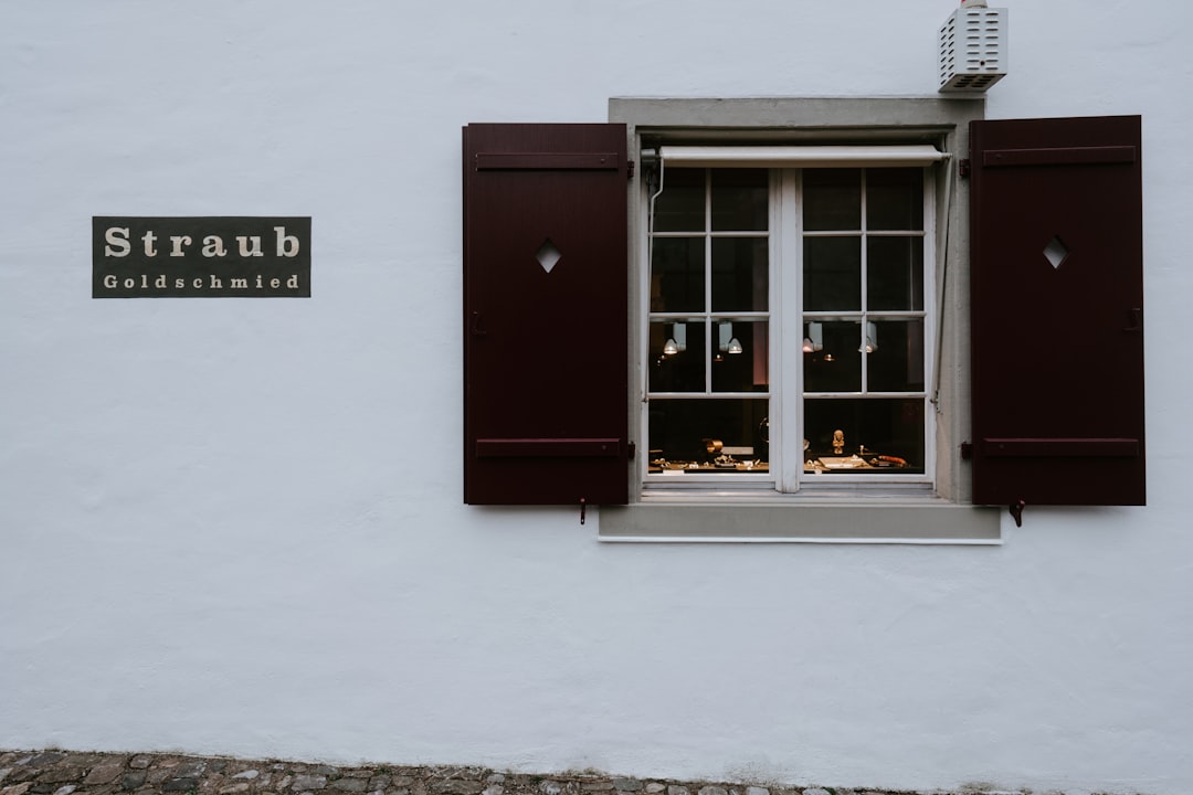 red wooden door with white wall