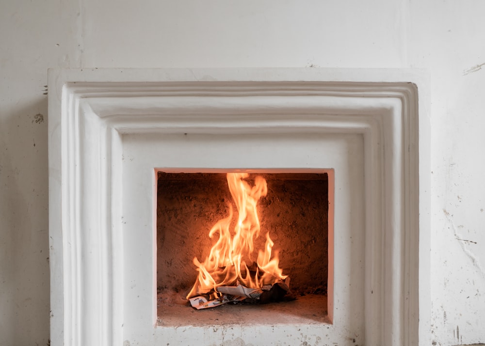 white wooden framed fire on gray concrete floor